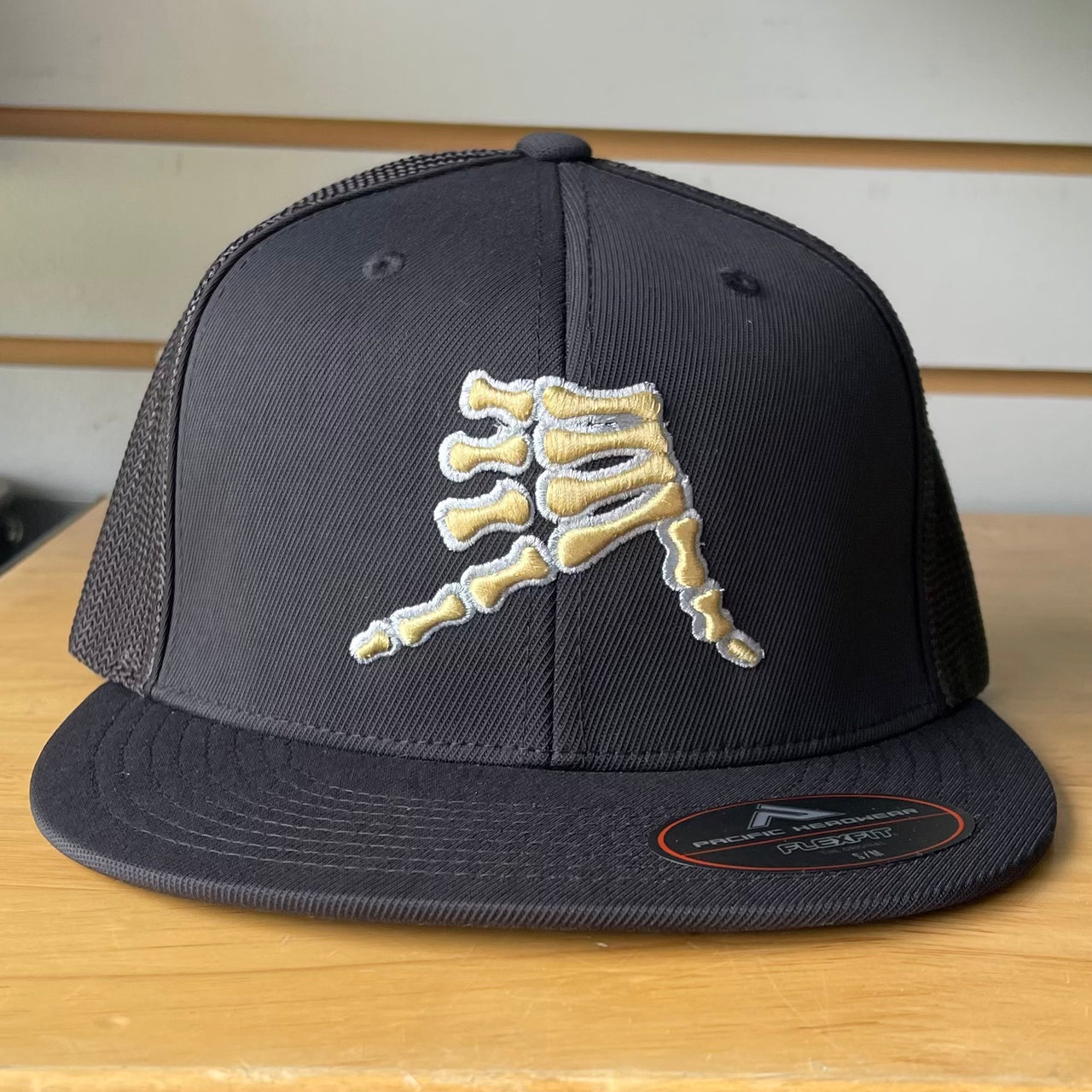 AkS Bones Flatbill Trucker Hat in Black with Gold & Silver