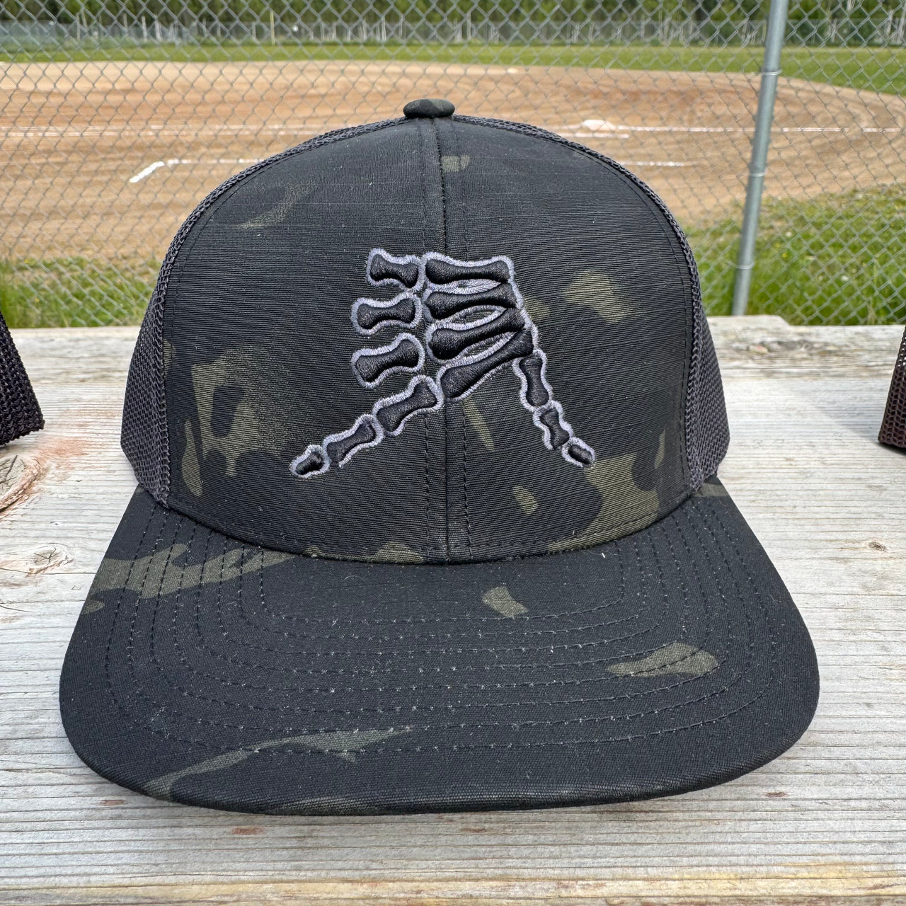 AkS Bones Snap-Back Trucker hat in Black Camo & Graphite