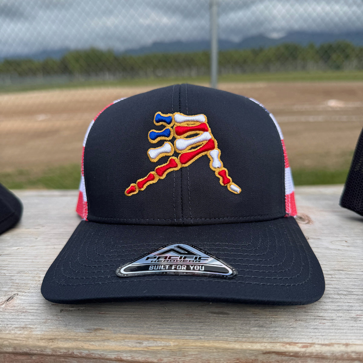 AkS Bones Stripes Snap-Back Trucker hat in Navy, Red and Flag